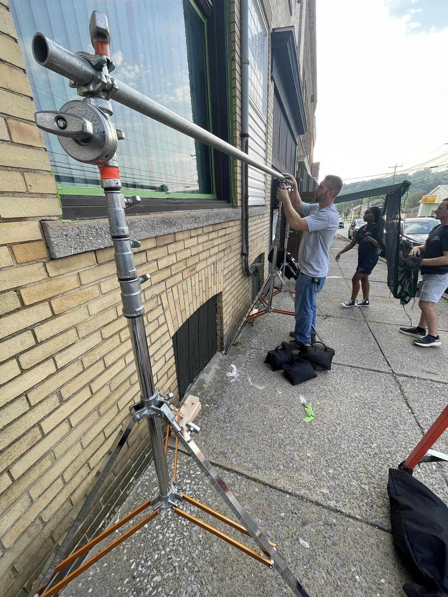 Professional film crew setting up equipment on location